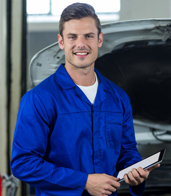 Car detailing expert applying wax and polishing the vehicle exterior
